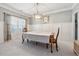 Elegant dining room featuring wainscoting, chandelier, and a large window with natural light at 2358 Well Springs Dr, Buford, GA 30519