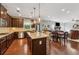 Open kitchen flowing into living space, featuring an island and stainless steel appliances at 2358 Well Springs Dr, Buford, GA 30519