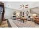 Living room with stone fireplace, comfortable sofas, and ceiling fan at 2358 Well Springs Dr, Buford, GA 30519