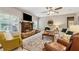 Cozy living room with a stone fireplace, ceiling fan, and ample seating at 2358 Well Springs Dr, Buford, GA 30519