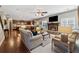 Open-concept living room features a fireplace, wood floors, and ample natural light at 2358 Well Springs Dr, Buford, GA 30519