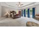 Spacious bedroom featuring a tray ceiling, plush carpet, and natural light from large windows at 2358 Well Springs Dr, Buford, GA 30519
