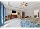 Large main bedroom featuring a ceiling fan, large windows, and an attached bathroom at 2358 Well Springs Dr, Buford, GA 30519