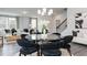 Bright dining area featuring a glass table, plush chairs, and views into the living room at 2719 Stream Valley Lane Nw Nw Cir, Atlanta, GA 30318