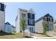 Charming three-story home with blue and gray siding and a well-maintained front yard at 2719 Stream Valley Lane Nw Nw Cir, Atlanta, GA 30318