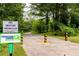 Walking path along the Proctor Creek Greenway with lush greenery and clear signage at 2719 Stream Valley Lane Nw Nw Cir, Atlanta, GA 30318