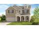 Charming two-story home features a brick facade, a covered porch, and an attached two-car garage at 3198 Shirecrest Ln, Dacula, GA 30019