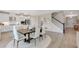 Open concept floor plan showing a dining table connected to a kitchen with stainless steel appliances at 3198 Shirecrest Ln, Dacula, GA 30019
