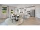 Eat-in kitchen features white cabinets, stainless steel appliances, a center island and a dining table at 3198 Shirecrest Ln, Dacula, GA 30019