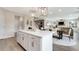 Open concept floor plan showcasing kitchen island, dining table, and a living room area at 3198 Shirecrest Ln, Dacula, GA 30019