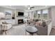 Open-concept living room with a fireplace, built-in shelving, large windows, and comfortable seating at 3198 Shirecrest Ln, Dacula, GA 30019