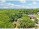 Aerial view of a home nestled among mature trees in a residential community at 3235 Munsey Ct, Cumming, GA 30041