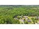 An aerial view displays several community homes nestled amongst mature trees at 3235 Munsey Ct, Cumming, GA 30041