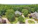 Aerial view of multiple homes showcasing landscaping and circular driveways at 3235 Munsey Ct, Cumming, GA 30041