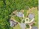 An aerial view displays the community homes nestled amongst mature trees at 3235 Munsey Ct, Cumming, GA 30041