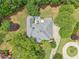 Aerial view of home's roof, hot tub, large private back yard, and circular driveway, showcasing its outdoor amenities at 3235 Munsey Ct, Cumming, GA 30041