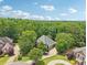 Stunning aerial view of a luxury home nestled in a lush, green landscape at 3235 Munsey Ct, Cumming, GA 30041