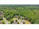 An aerial view displays several community homes nestled amongst mature trees at 3235 Munsey Ct, Cumming, GA 30041