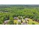 This high-angle shot reveals luxury homes nestled among dense trees, with winding roads visible at 3235 Munsey Ct, Cumming, GA 30041
