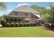 The brick home has a covered porch, an outdoor dining area, and a hot tub in the backyard at 3235 Munsey Ct, Cumming, GA 30041