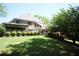 Expansive backyard features a spacious deck, lush lawn and mature trees, perfect for outdoor living at 3235 Munsey Ct, Cumming, GA 30041