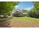 Beautiful backyard showcasing lush green grass and mature trees, perfect for relaxation and outdoor activities at 3235 Munsey Ct, Cumming, GA 30041