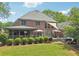 Backyard with screened porch, landscaping, and a hot tub at 3235 Munsey Ct, Cumming, GA 30041