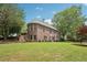 Expansive backyard featuring mature trees and lush green lawn, ideal for outdoor activities at 3235 Munsey Ct, Cumming, GA 30041