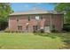 Home exterior, featuring a well-maintained lawn, neatly trimmed bushes, and a classic brick facade at 3235 Munsey Ct, Cumming, GA 30041
