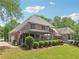 The backyard has a well-maintained lawn, landscaping, patio, and a hot tub at 3235 Munsey Ct, Cumming, GA 30041
