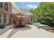 Backyard deck features an outdoor table, and a hot tub area great for entertaining at 3235 Munsey Ct, Cumming, GA 30041