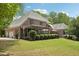 Backyard features a well-maintained lawn and mature trees for privacy and outdoor enjoyment at 3235 Munsey Ct, Cumming, GA 30041
