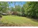 Picturesque backyard featuring a well-manicured lawn and mature trees, ideal for outdoor recreation and enjoyment at 3235 Munsey Ct, Cumming, GA 30041