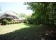 Expansive backyard featuring a well-maintained lawn and mature trees, providing privacy at 3235 Munsey Ct, Cumming, GA 30041