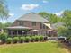 Spacious backyard featuring a deck, hot tub, and lush green lawn at 3235 Munsey Ct, Cumming, GA 30041