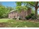 Back exterior showing a brick home with a spacious, well-maintained lawn at 3235 Munsey Ct, Cumming, GA 30041