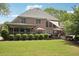 The backyard has a covered patio, green lawn, and inviting outdoor space for entertaining and relaxation at 3235 Munsey Ct, Cumming, GA 30041