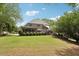 The backyard has a covered patio, a well-manicured lawn, and lush greenery to enjoy outdoor living at 3235 Munsey Ct, Cumming, GA 30041