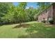 Back exterior featuring a wide green lawn, perfect for outdoor activities and relaxation at 3235 Munsey Ct, Cumming, GA 30041