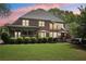 Beautiful backyard with a screened porch, patio, hot tub, and lush greenery at 3235 Munsey Ct, Cumming, GA 30041