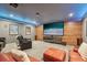Entertainment basement with a large viewing screen, wood accent wall, and ambient lighting at 3235 Munsey Ct, Cumming, GA 30041