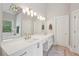 Bathroom with double vanity, soaking tub, shower, and modern light fixture at 3235 Munsey Ct, Cumming, GA 30041