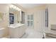 Bathroom featuring a white vanity with marble countertop, window with shutters, and white tile flooring at 3235 Munsey Ct, Cumming, GA 30041