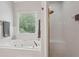 Modern bathroom with soaking tub, shower, and window at 3235 Munsey Ct, Cumming, GA 30041