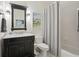 Well-lit bathroom featuring modern vanity, brushed nickel fixtures, and shower-tub combination at 3235 Munsey Ct, Cumming, GA 30041