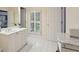 Bright bathroom features white cabinets, granite countertops, and a shuttered window at 3235 Munsey Ct, Cumming, GA 30041