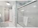 A clean and modern bathroom with a glass-enclosed shower and white striped walls at 3235 Munsey Ct, Cumming, GA 30041