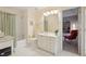 Well-lit bathroom with a shower/tub, single vanity, and view to the adjacent room at 3235 Munsey Ct, Cumming, GA 30041