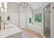Bright bathroom with double vanity, soaking tub, walk-in shower, and modern light fixture at 3235 Munsey Ct, Cumming, GA 30041