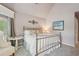 Bedroom with plush carpet, a decorative iron bed frame, and natural light from a large window at 3235 Munsey Ct, Cumming, GA 30041